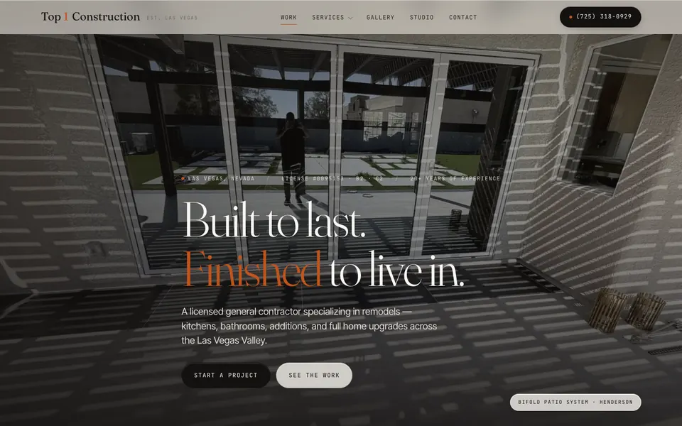The Top 1 Construction homepage showing a large photo of a patio with bifold glass doors and the headline Built to last. Finished to live in. for a Las Vegas general contractor